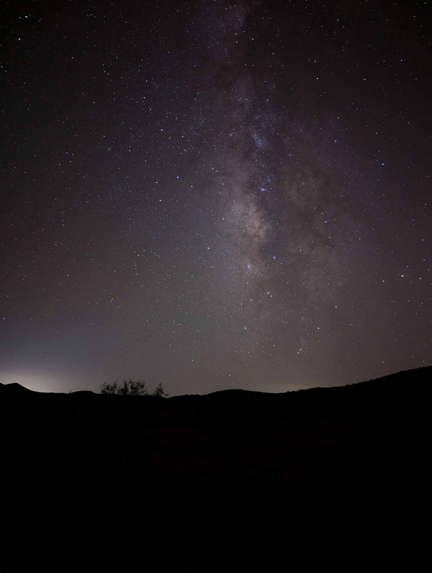 Image of Milky way with hills in the foreground.